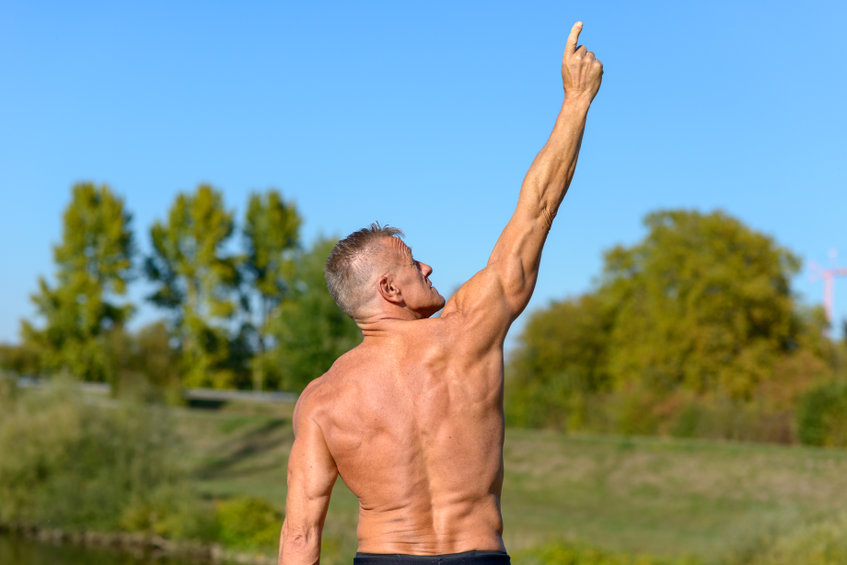 Strong man pointing to the sky